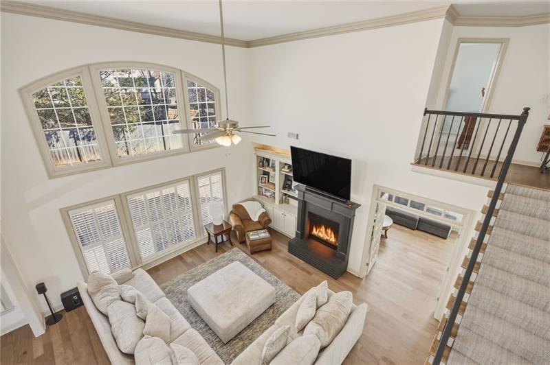 4862 Manatee Court Northwest Powder Springs, GA 30127 - Photo 24 of 46 a living room with furniture a fireplace and a flat screen tv