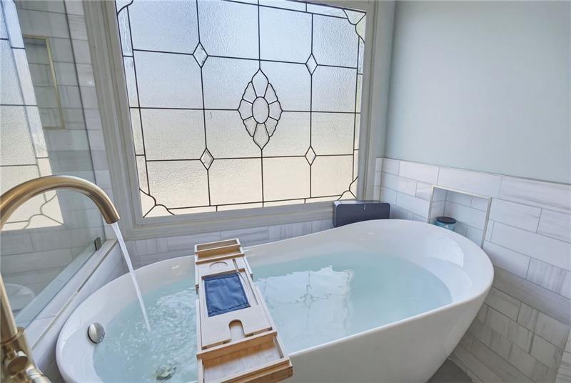 4862 Manatee Court Northwest Powder Springs, GA 30127 - Photo 29 of 46 a picture of a bath tub sitting in a bathroom