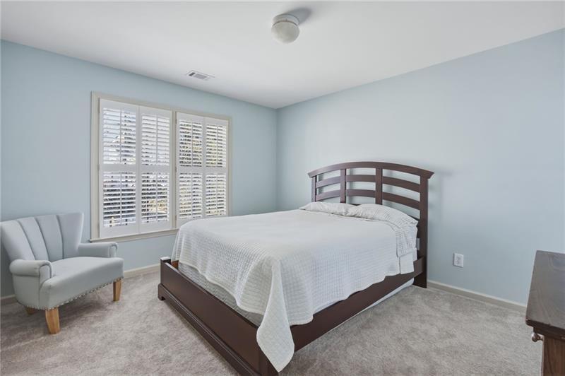 4862 Manatee Court Northwest Powder Springs, GA 30127 - Photo 31 of 46 a spacious bedroom with a bed and a couch