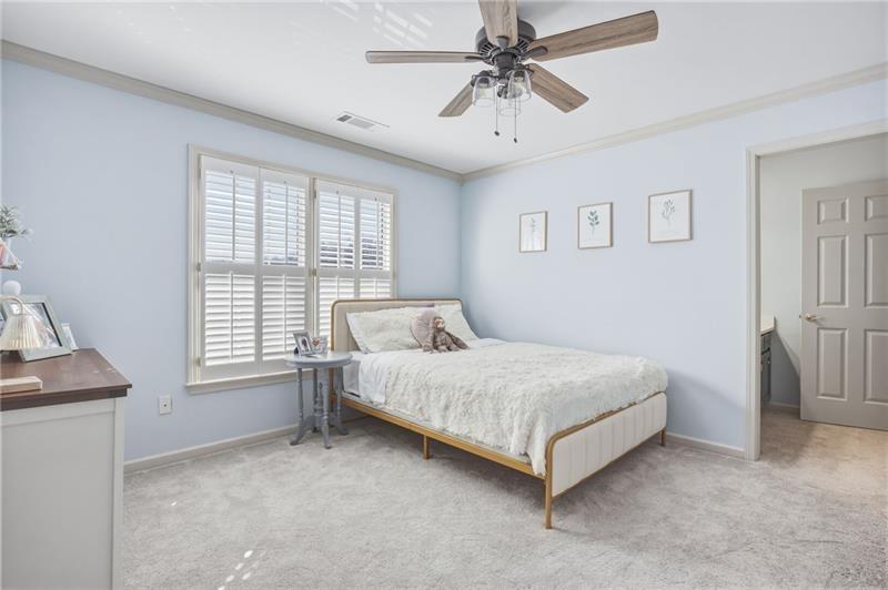 4862 Manatee Court Northwest Powder Springs, GA 30127 - Photo 33 of 46 a spacious bedroom with a bed and a chandelier