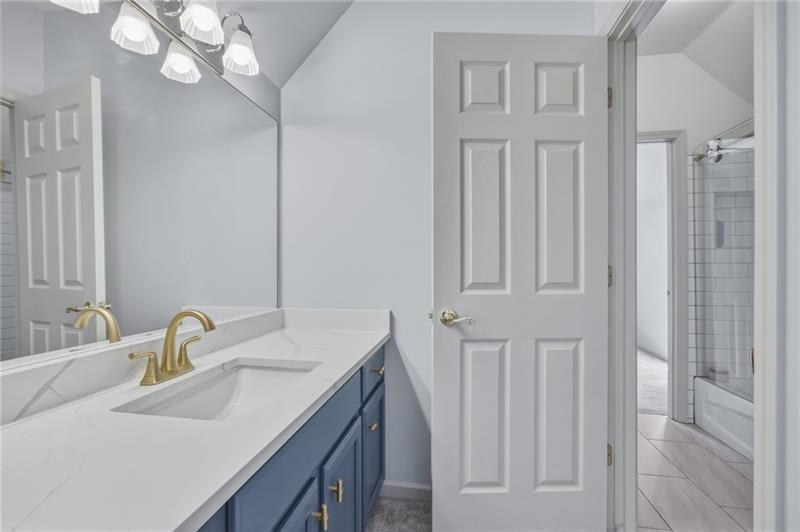 4862 Manatee Court Northwest Powder Springs, GA 30127 - Photo 34 of 46 a bathroom with a sink vanity and a mirror