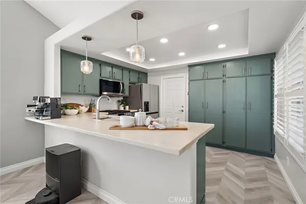 a large kitchen with a table and chairs in it
