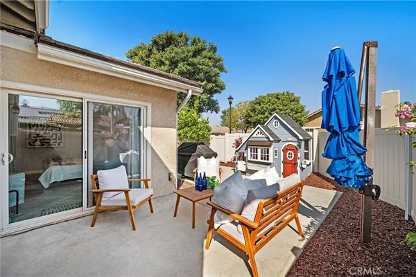 a backyard of a house with table and chairs