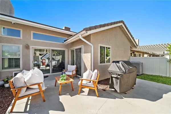 a view of a patio with a dining table and chairs