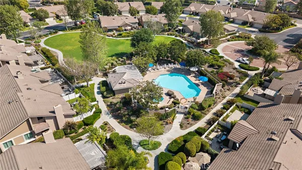 an aerial view of a house with yard swimming pool and outdoor seating