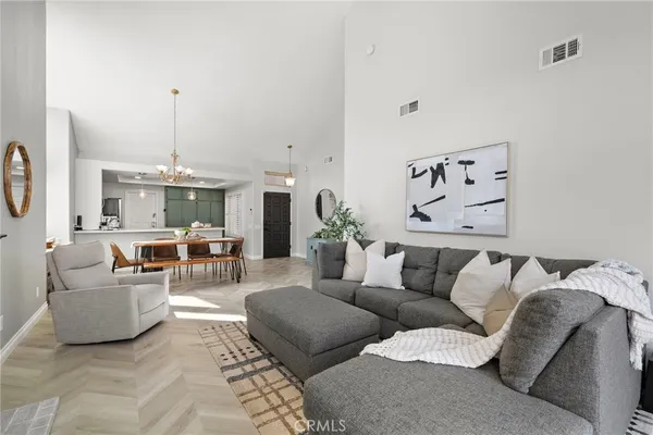 a living room with furniture and a chandelier