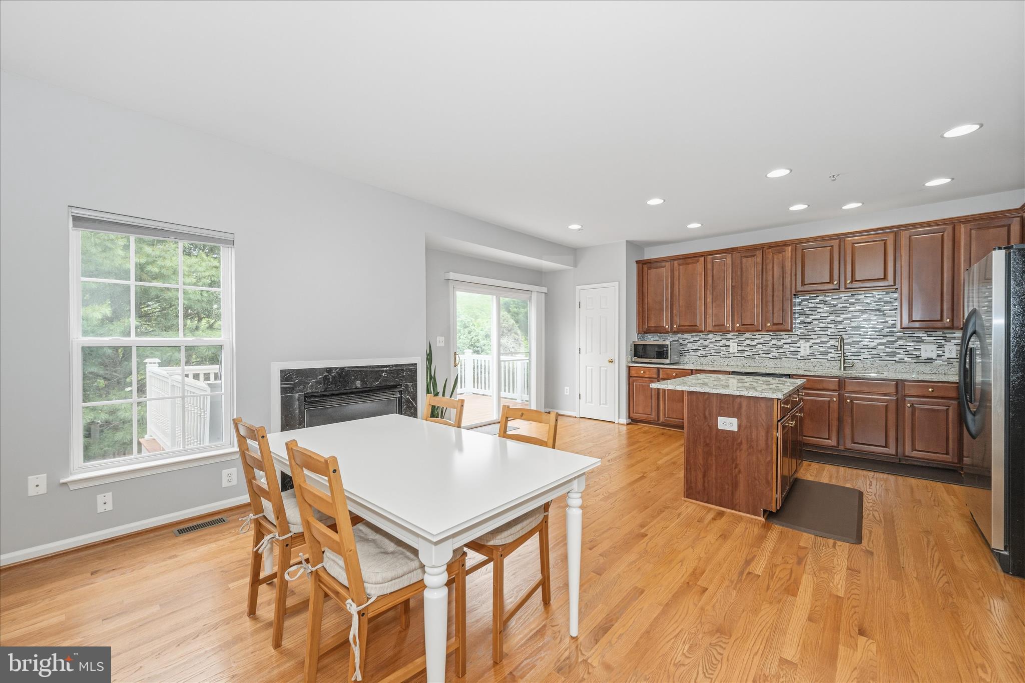 21 Inkberry Circle Gaithersburg, MD 20877 - Photo 11 of 51 a kitchen with a table chairs a sink dishwasher window and cabinets