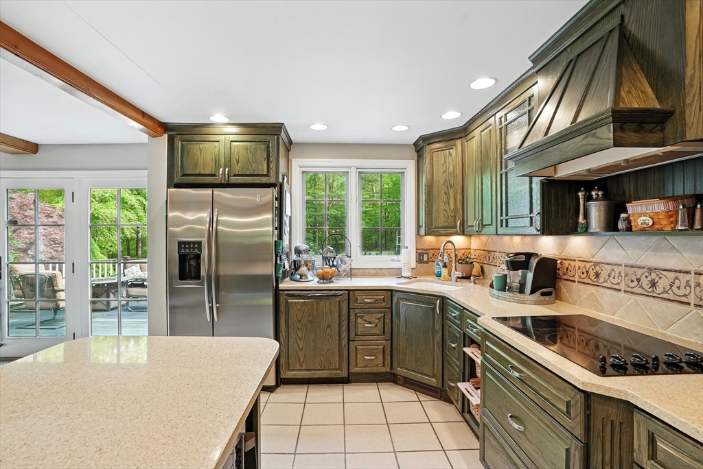 56 Grafton Road Upton, MA 01568 - Photo 11 of 34 a kitchen with stainless steel appliances a sink stove and refrigerator
