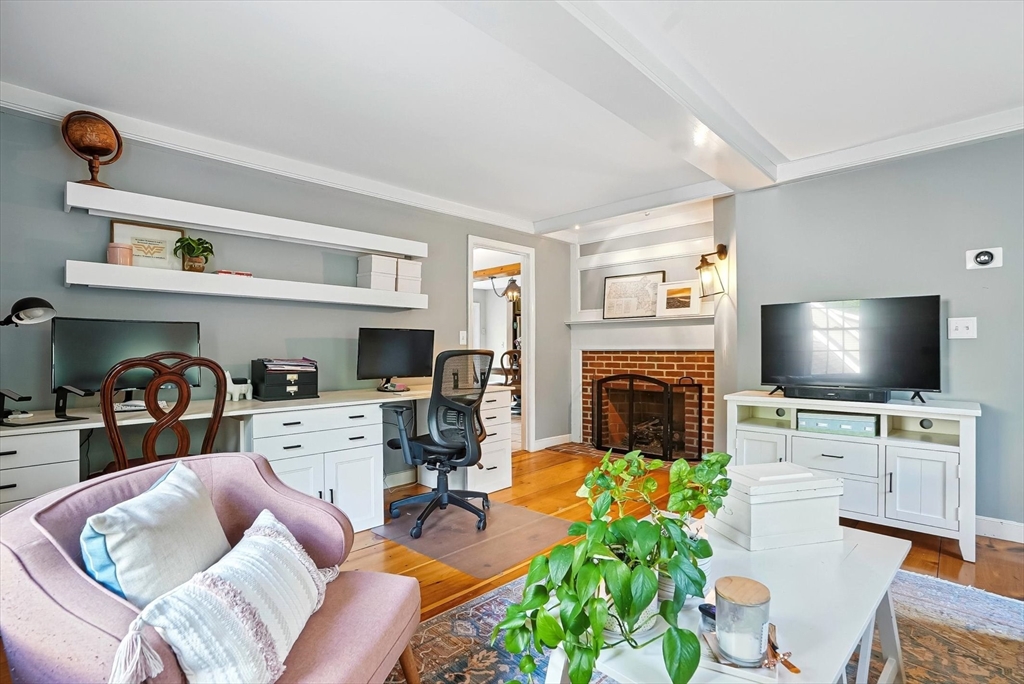 56 Grafton Road Upton, MA 01568 - Photo 17 of 34 a living room with furniture a flat screen tv and a fireplace