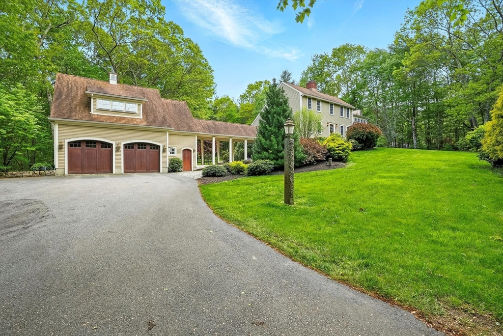 56 Grafton Road Upton, MA 01568 - Photo 2 of 34 a front view of a house with a yard and trees