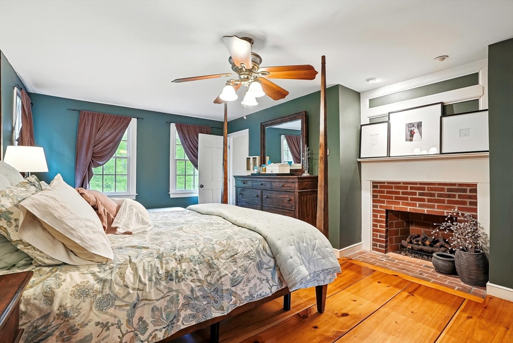 56 Grafton Road Upton, MA 01568 - Photo 21 of 34 a bedroom with a bed and a fireplace