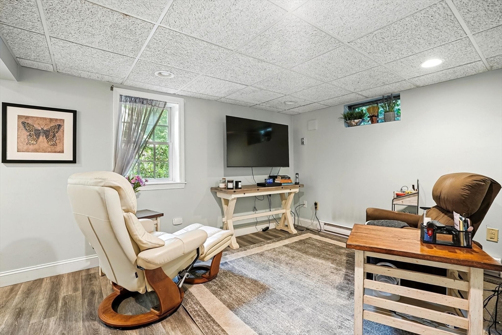 56 Grafton Road Upton, MA 01568 - Photo 28 of 34 a living room with furniture and a flat screen tv