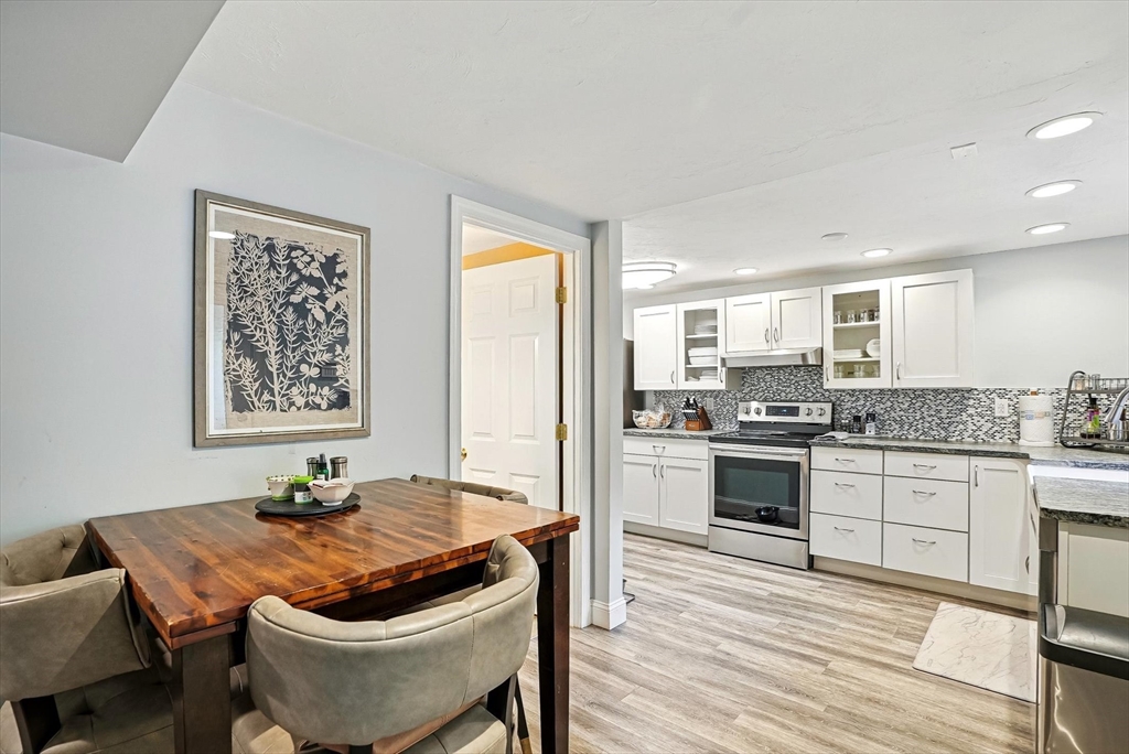 56 Grafton Road Upton, MA 01568 - Photo 29 of 34 a kitchen with granite countertop a stove and white cabinets
