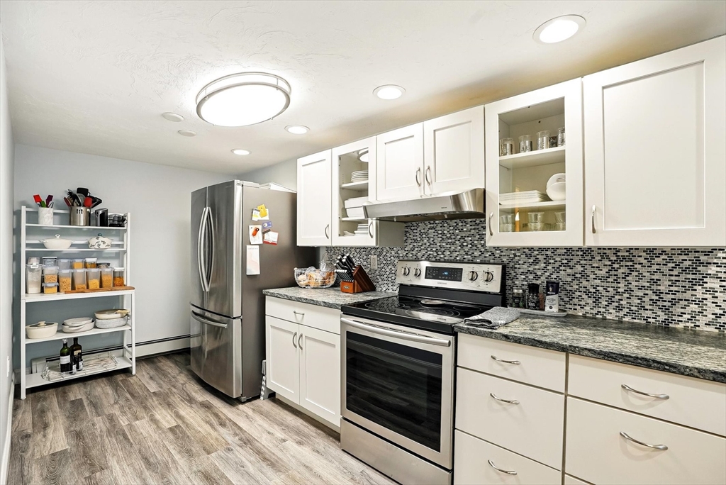 56 Grafton Road Upton, MA 01568 - Photo 30 of 34 a kitchen with stainless steel appliances granite countertop a stove sink and cabinets