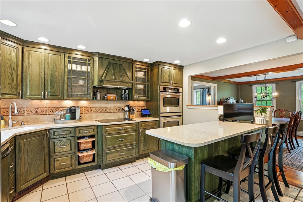 56 Grafton Road Upton, MA 01568 - Photo 10 of 34 a kitchen with a stove a sink and cabinets