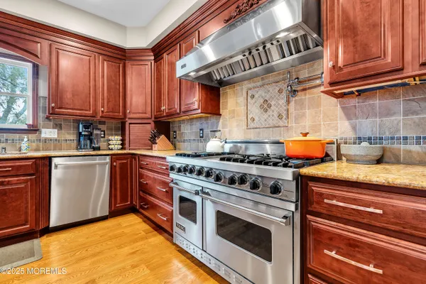 a kitchen with stainless steel appliances granite countertop a stove and a sink