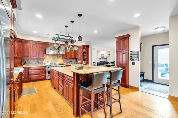 a large kitchen with kitchen island a sink table and chairs