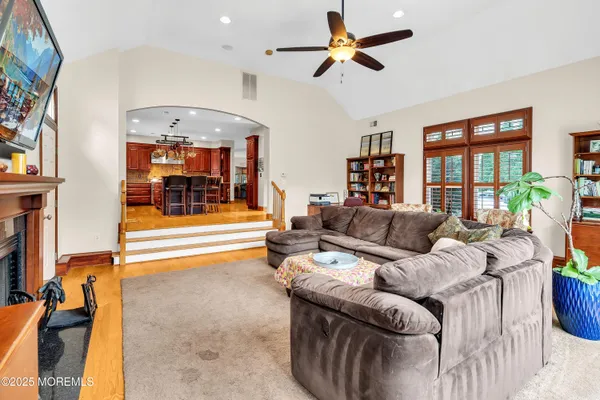 a living room with furniture and a chandelier