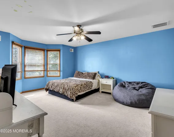 a spacious bedroom with a bed and window