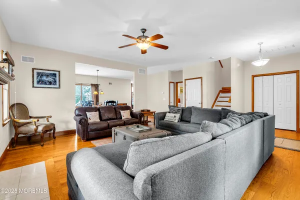 a living room with furniture and a chandelier
