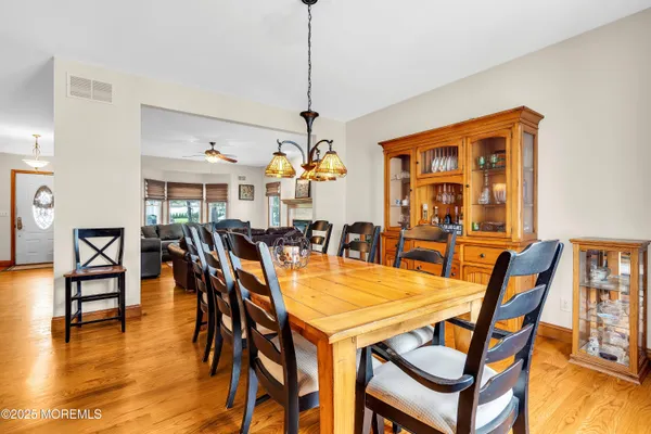 a dining room with furniture and wooden floor