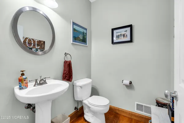 a bathroom with a toilet a sink and a mirror