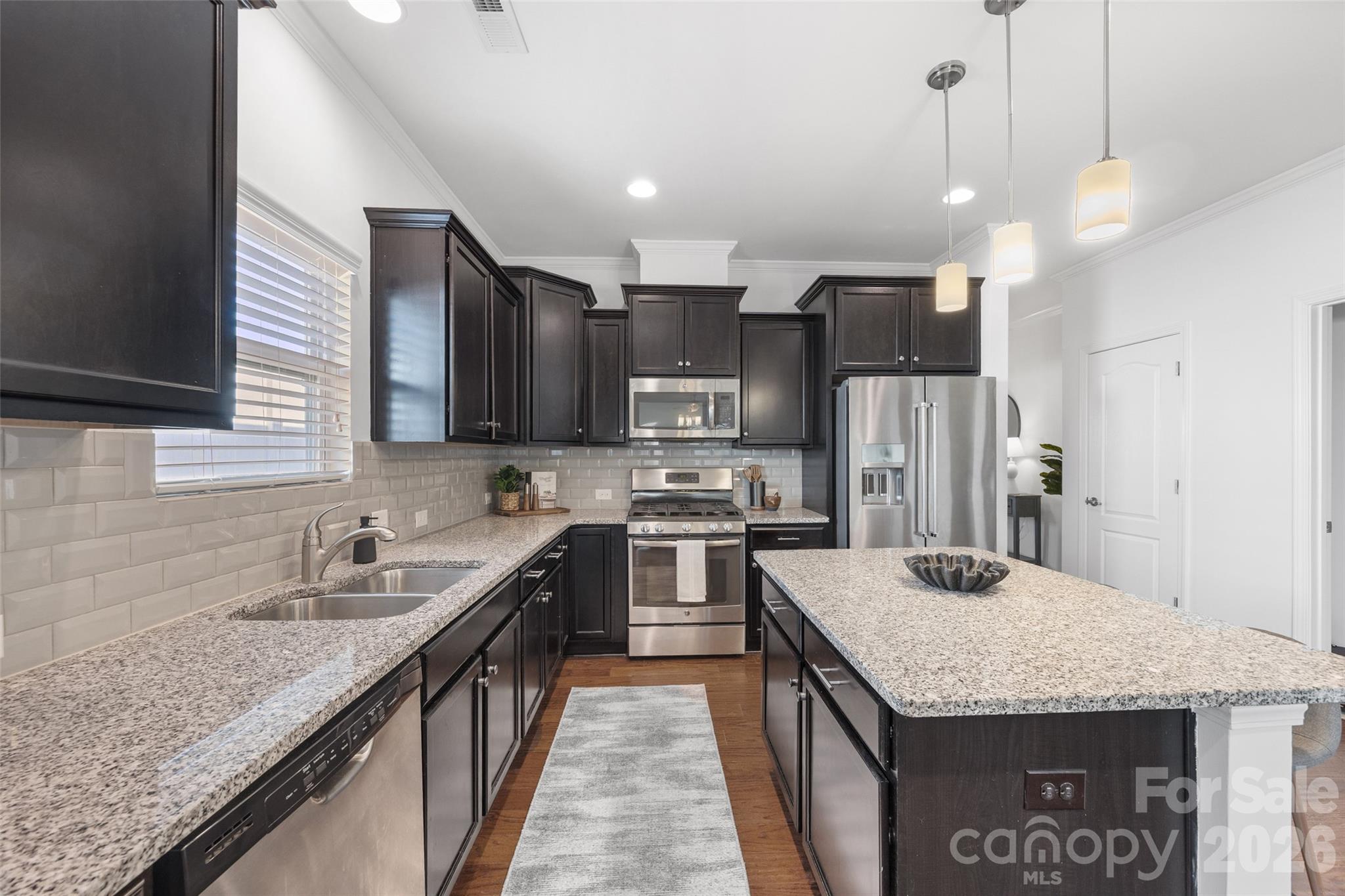 1214 Brookcrest Lane Fort Mill, SC 29708 - Photo 14 of 41 a kitchen with stainless steel appliances granite countertop a sink stove and refrigerator