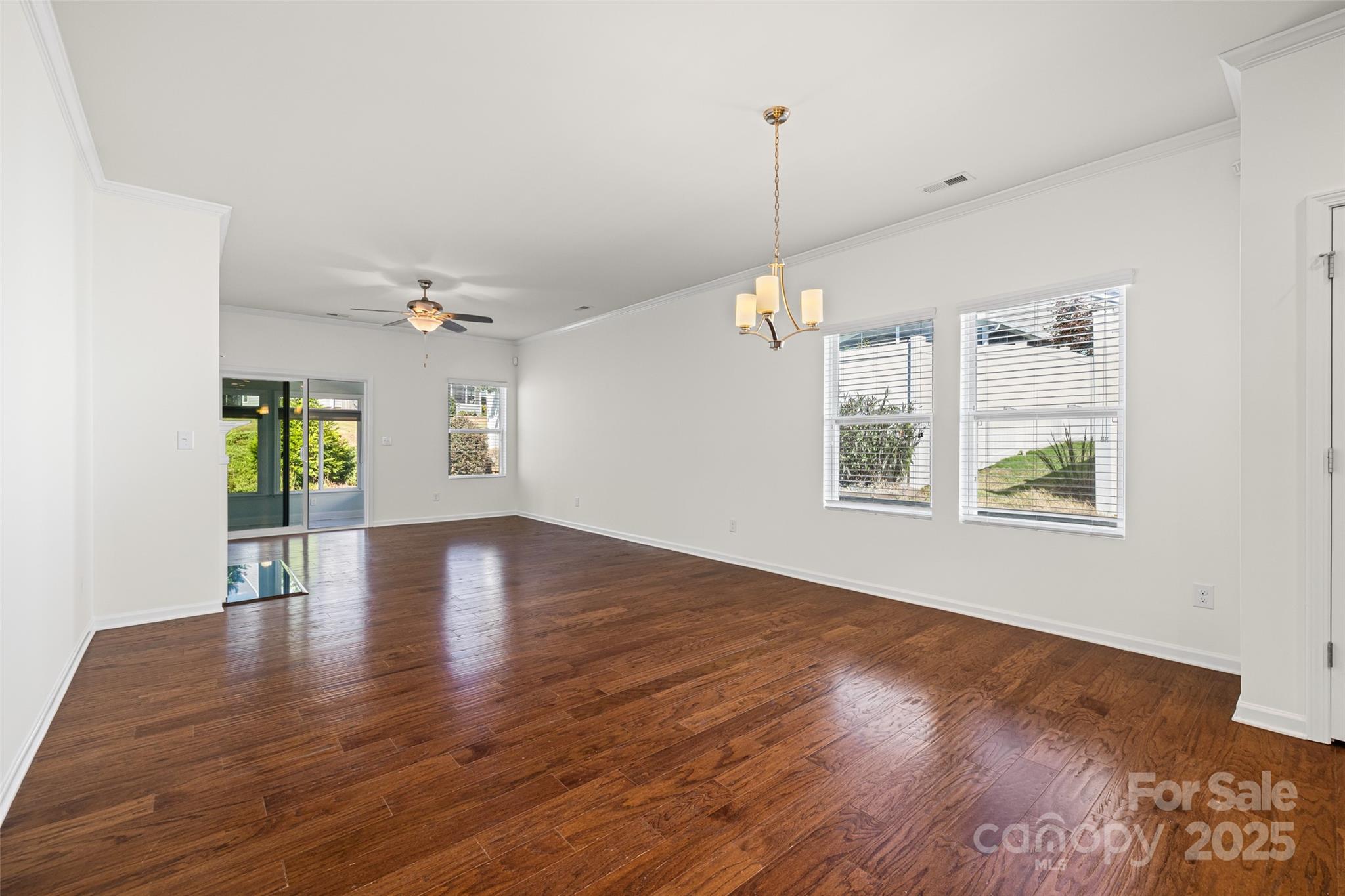 1214 Brookcrest Lane Fort Mill, SC 29708 - Photo 15 of 41 a view of an empty room with window and wooden floor