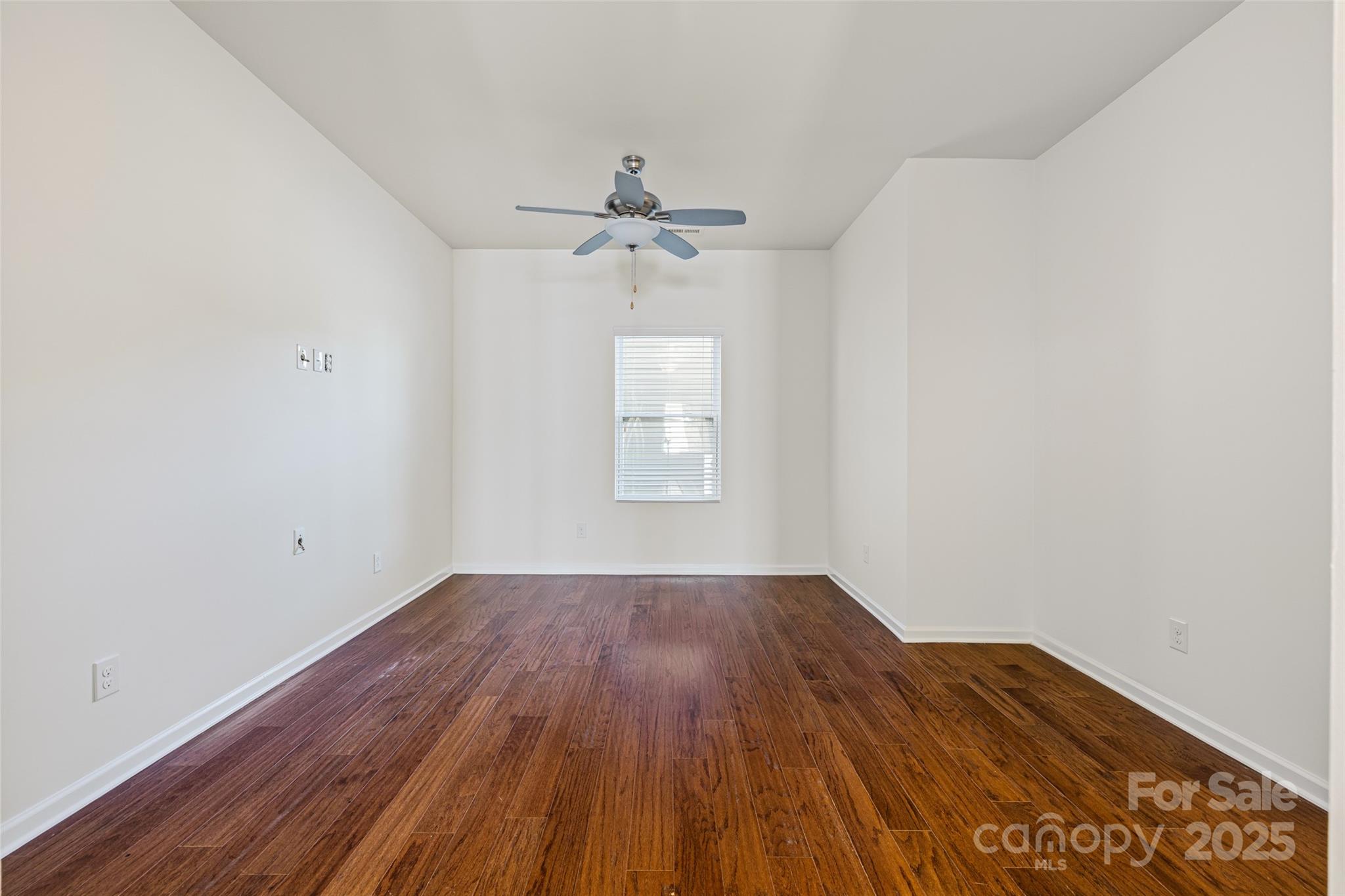 1214 Brookcrest Lane Fort Mill, SC 29708 - Photo 19 of 41 an empty room with wooden floor ceiling fan and windows