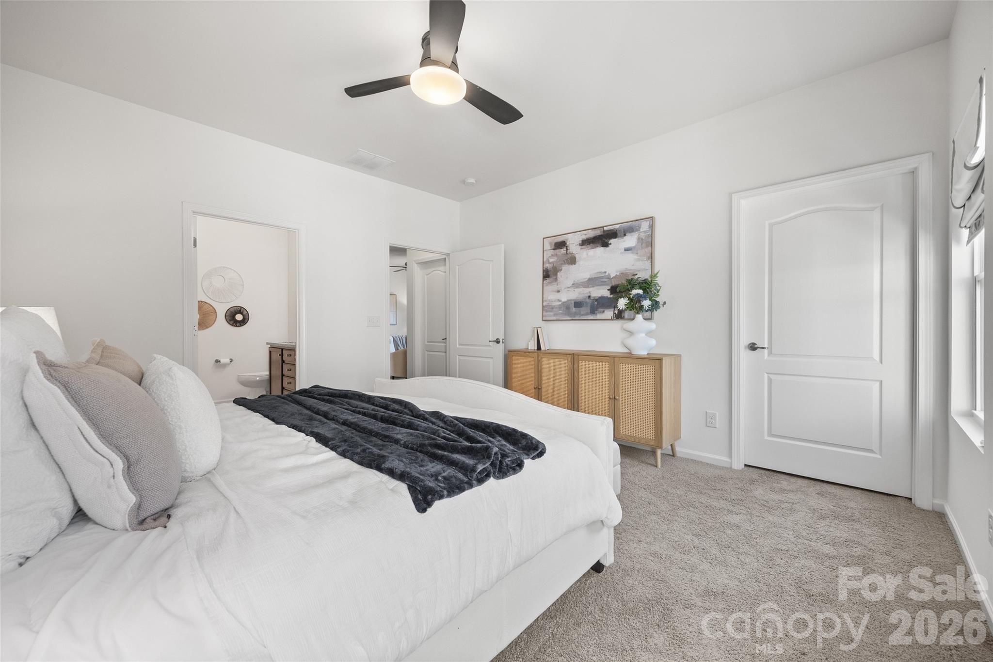 1214 Brookcrest Lane Fort Mill, SC 29708 - Photo 24 of 41 a bedroom with a large bed and a chandelier