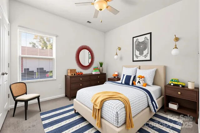 a bedroom with bed and a chandelier