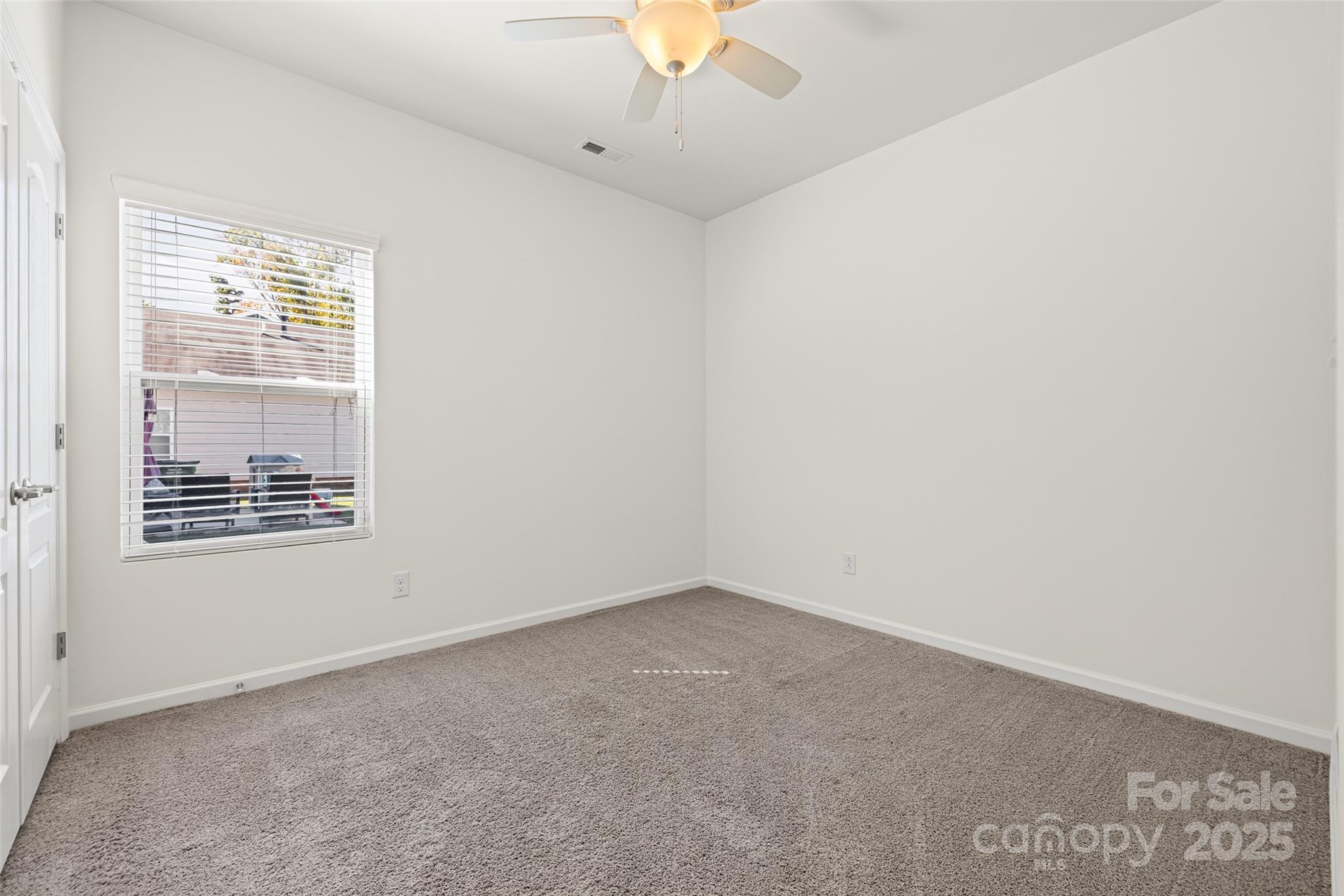1214 Brookcrest Lane Fort Mill, SC 29708 - Photo 29 of 41 an empty room with a window and a ceiling fan