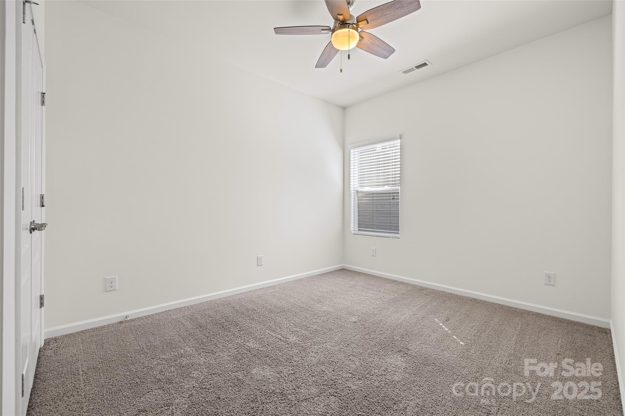 1214 Brookcrest Lane Fort Mill, SC 29708 - Photo 31 of 41 an empty room with a chandelier fan and windows