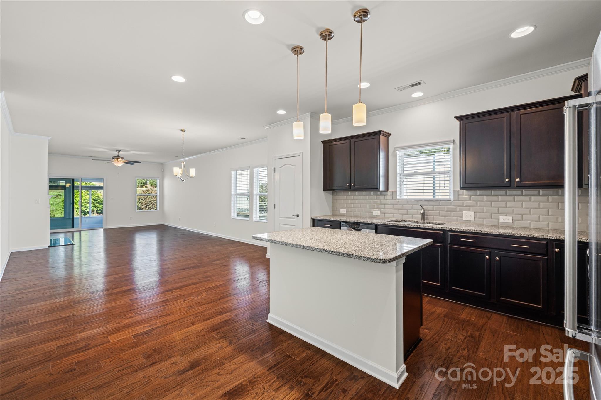 1214 Brookcrest Lane Fort Mill, SC 29708 - Photo 7 of 41 a kitchen with stainless steel appliances granite countertop a sink stove and wooden floor