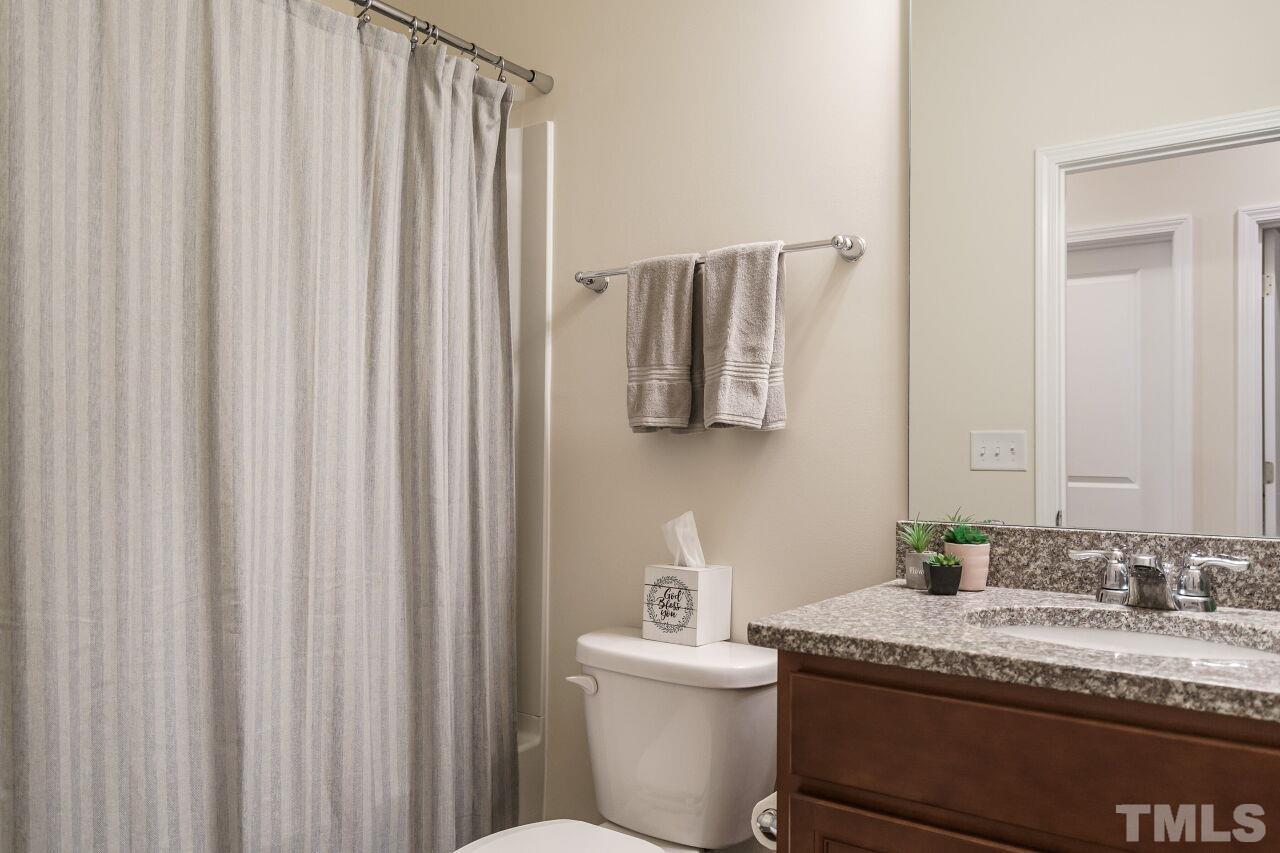 4100 Catfish Wy. Durham, NC 27703 - Photo 22 of 29 a bathroom with a granite countertop sink and a mirror