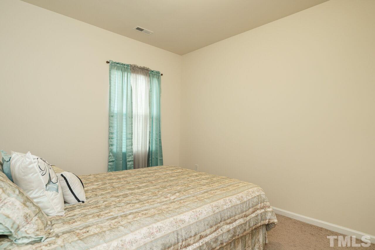 4100 Catfish Wy. Durham, NC 27703 - Photo 23 of 29 a bedroom with a bed and a window