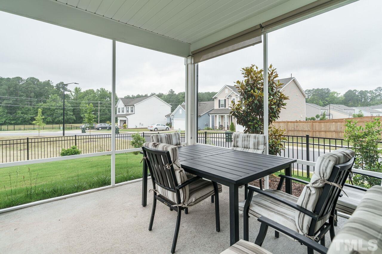 4100 Catfish Wy. Durham, NC 27703 - Photo 24 of 29 a view of a patio with a table chairs and a backyard