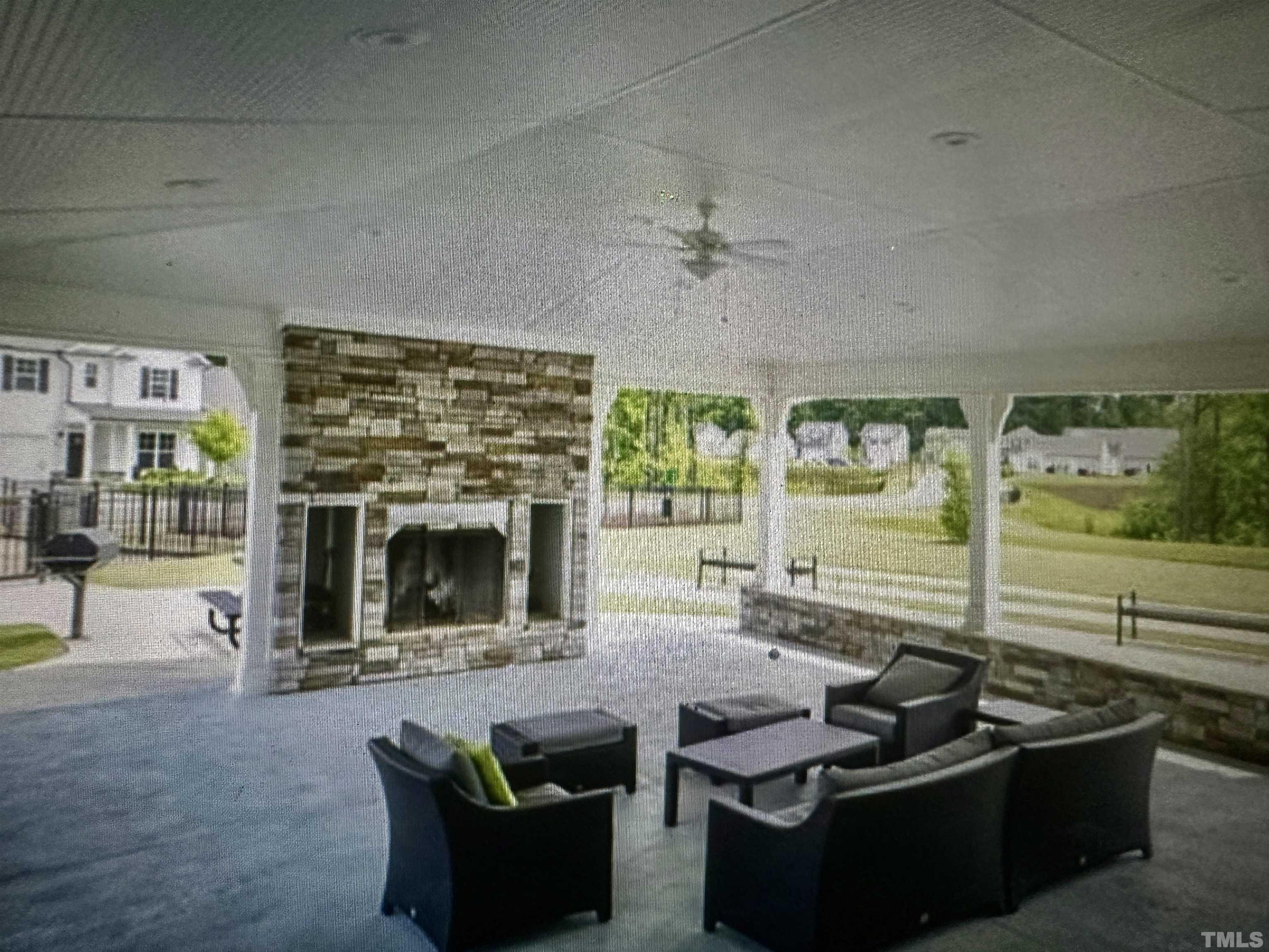 4100 Catfish Wy. Durham, NC 27703 - Photo 29 of 29 a living room with furniture a fireplace and a floor to ceiling window
