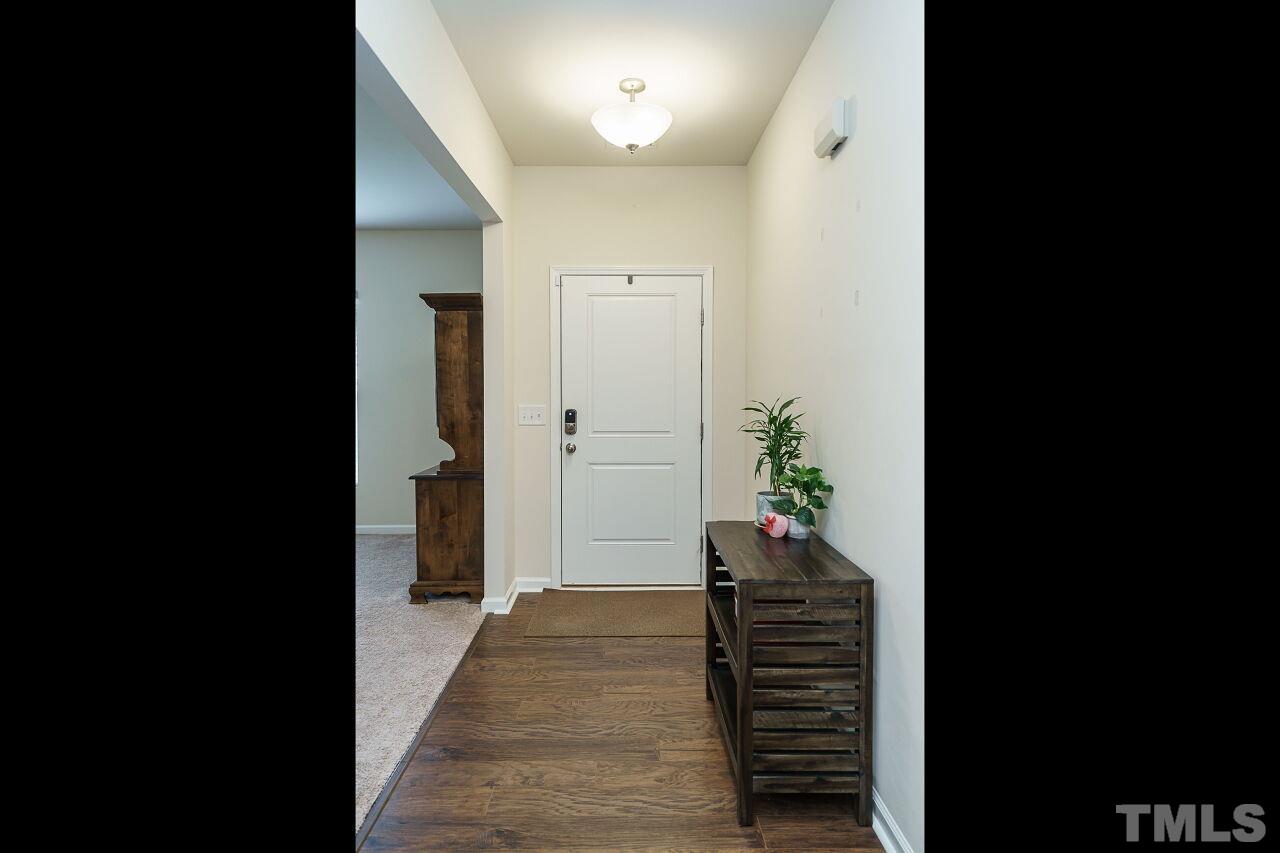 4100 Catfish Wy. Durham, NC 27703 - Photo 4 of 29 a view of a hallway and stairs and wooden floor