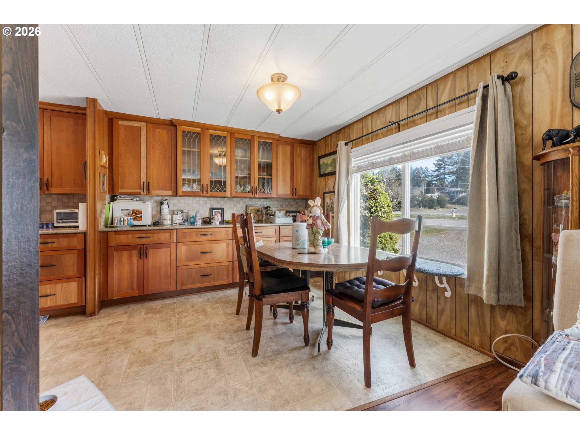 735 North 8th Street Lakeside, OR 97449 - Photo 13 of 45 a dining room with a wooden table and chairs