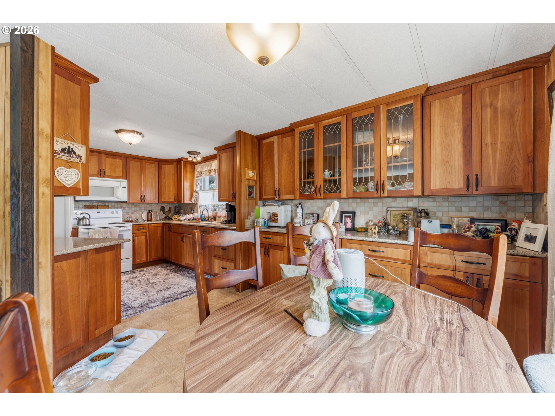 735 North 8th Street Lakeside, OR 97449 - Photo 14 of 45 a kitchen with stainless steel appliances granite countertop a refrigerator stove top oven and large cabinets with wooden floor