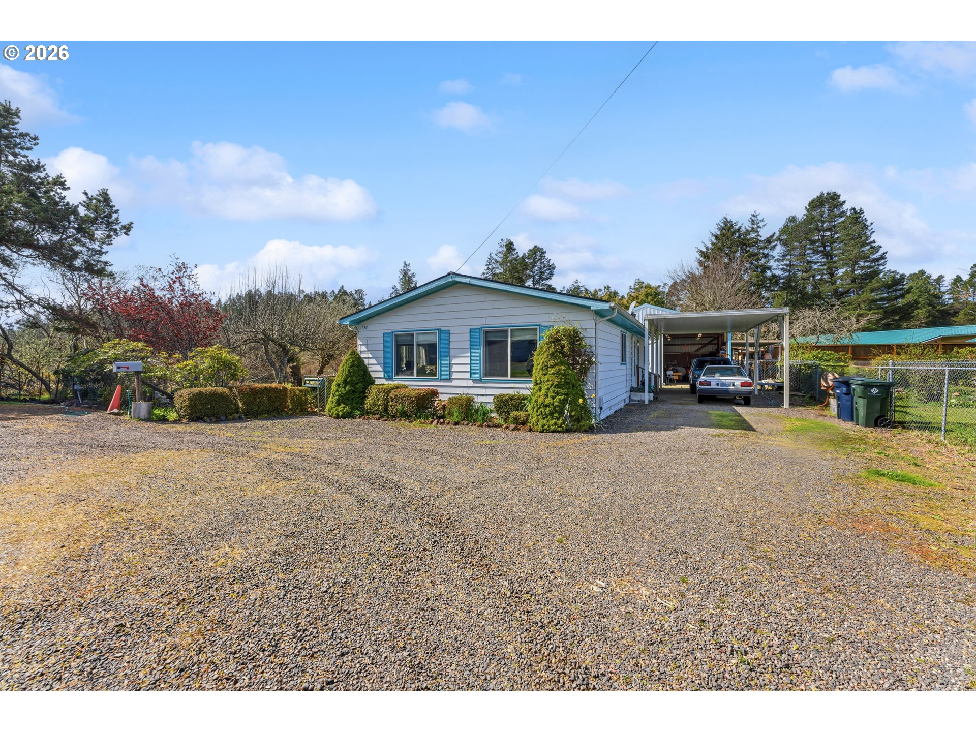 735 North 8th Street Lakeside, OR 97449 - Photo 2 of 45 a front view of a house with a garden