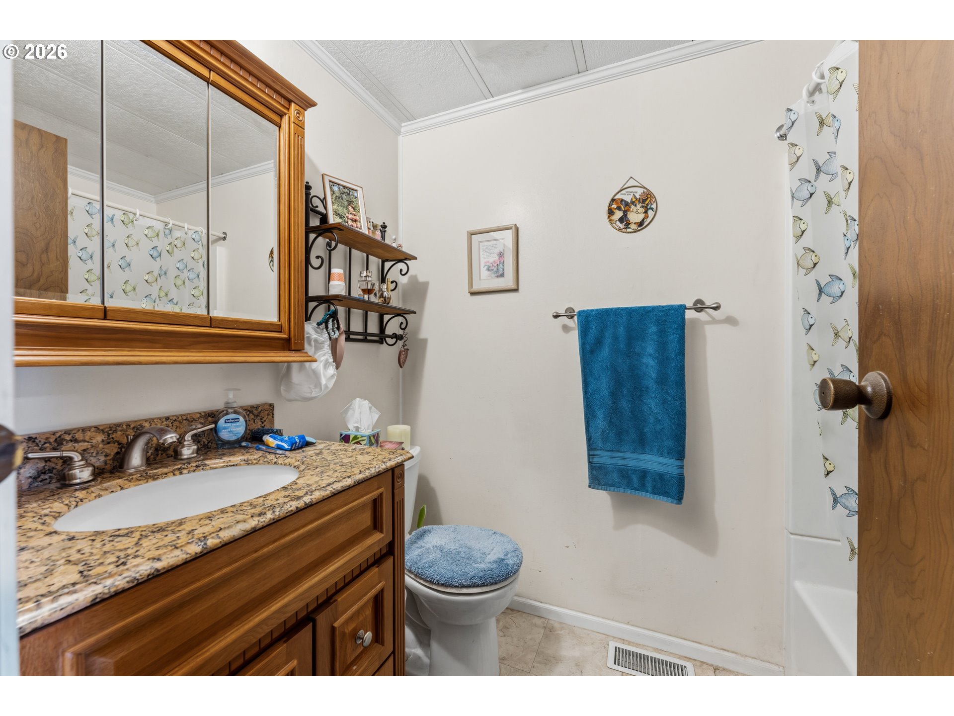 735 North 8th Street Lakeside, OR 97449 - Photo 22 of 45 a bathroom with a granite countertop sink mirror vanity and toilet