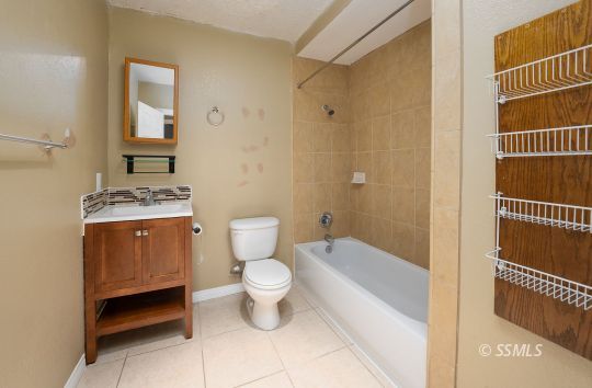 231 North Kern Street Ridgecrest, CA 93555 - Photo 11 of 41 a bathroom with a toilet a sink and bathtub
