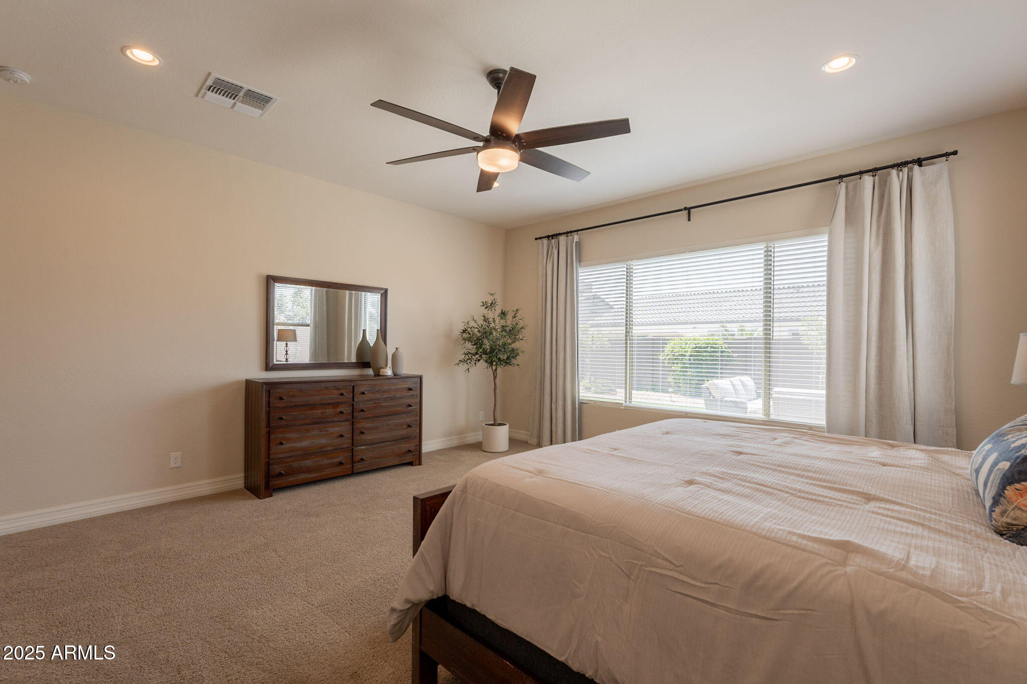 22863 East Russet Road Queen Creek, AZ 85142 - Photo 31 of 77 a bedroom with a bed and a chandelier
