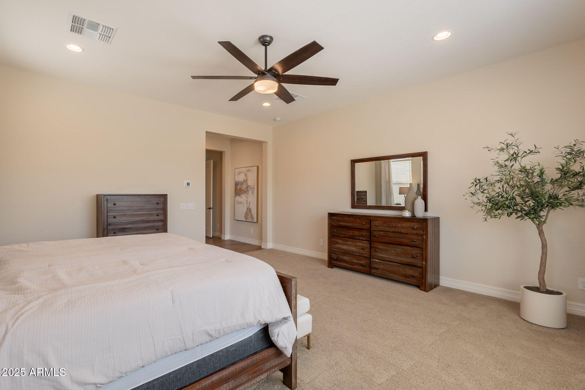 22863 East Russet Road Queen Creek, AZ 85142 - Photo 33 of 77 a bedroom with a bed and a potted plant