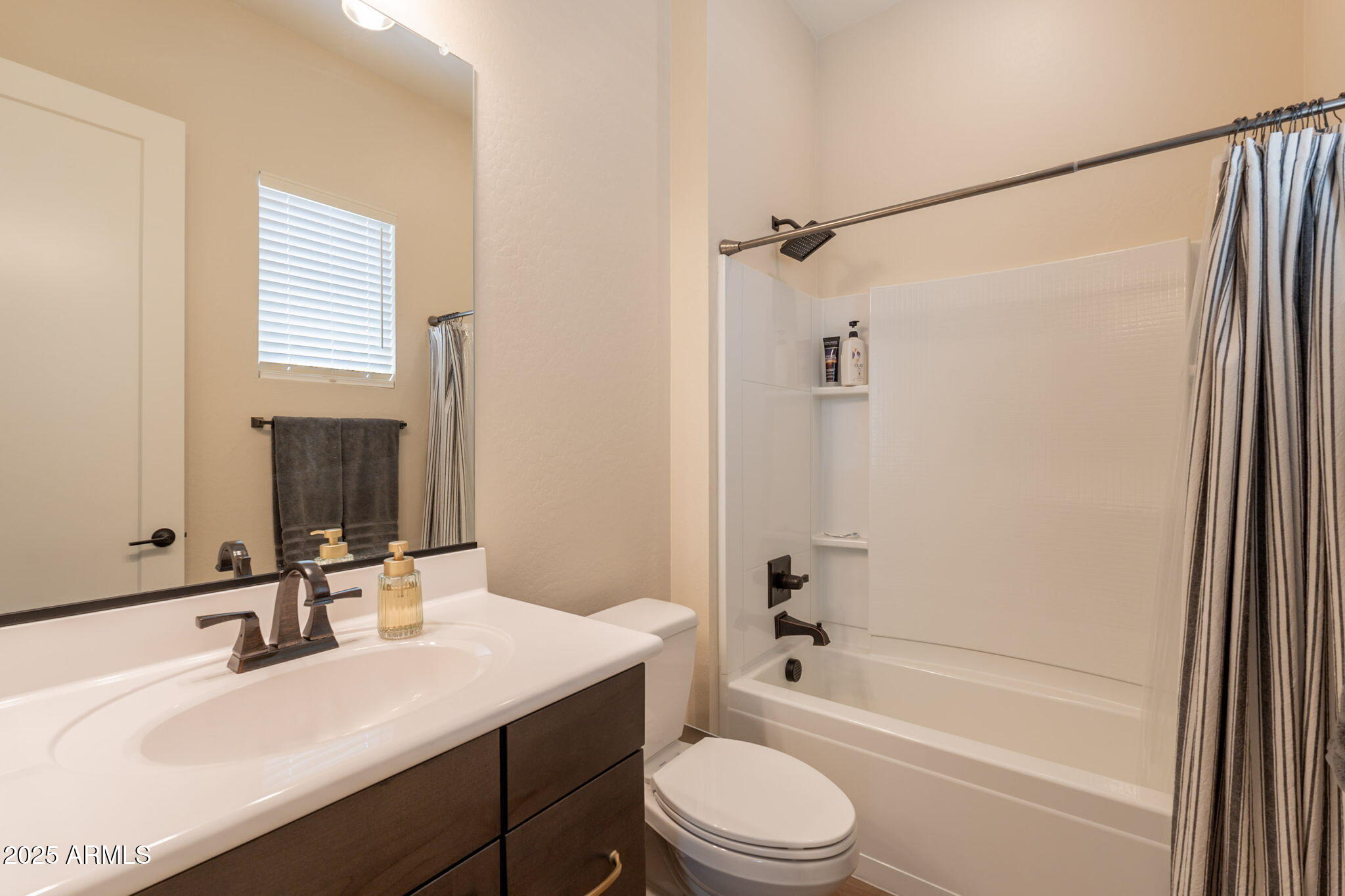 22863 East Russet Road Queen Creek, AZ 85142 - Photo 46 of 77 a bathroom with a bathtub shower sink vanity mirror and toilet