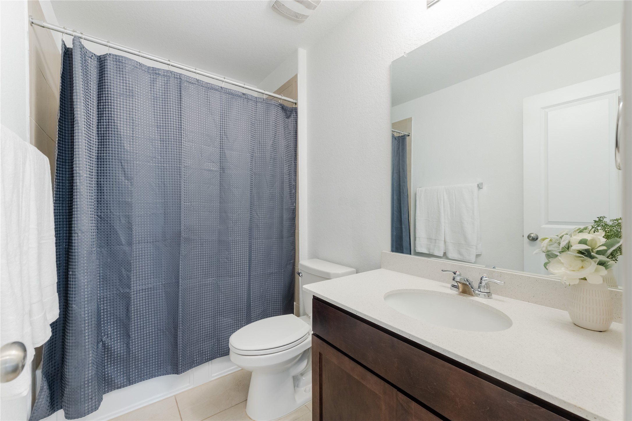 425 Perfect World Loop Jarrell, TX 76537 - Photo 18 of 29 Bathroom featuring a single vanity with a white countertop, dark wood-finish cabinetry, and a chrome faucet