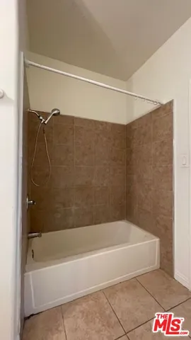 a bathroom with a shower and a bath tub