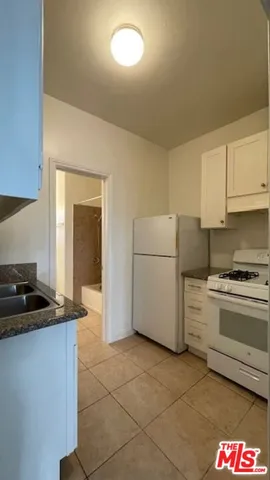 a kitchen with a cabinets and a stove top oven